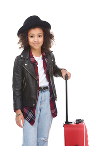 smiling little child with luggage looking at camera isolated on white