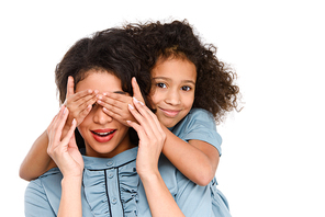 daughter covering eyes of surprised mother with hands isolated on white
