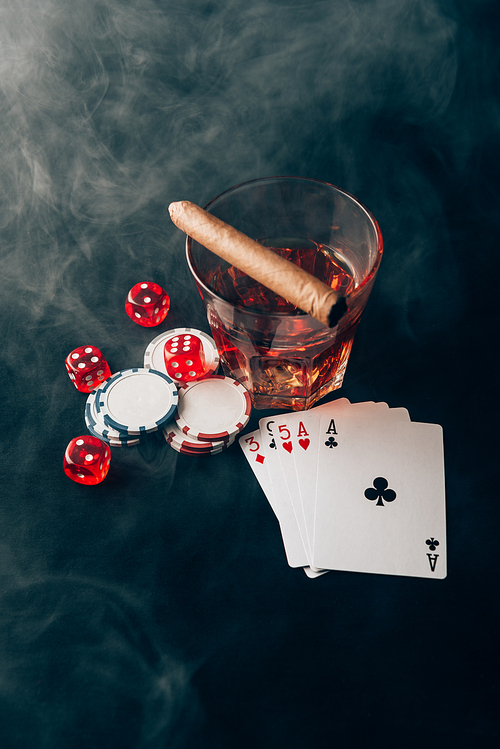 Gambling concept with whiskey on casino table with cards and dice