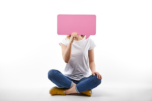 woman with pink speech bubble in hands sitting isolated on white