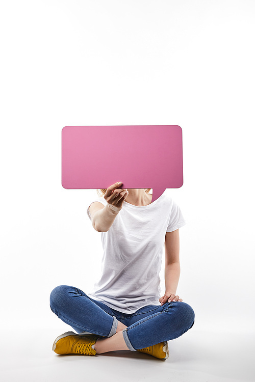 woman with pink speech bubble in hand sitting isolated on white