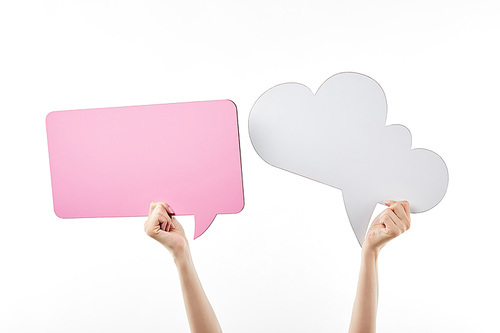 cropped view of woman with pink thought and speech bubbles in hands isolated on white