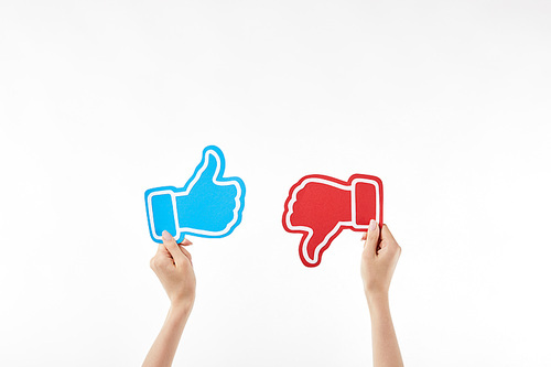 cropped view of woman with blue thumb up and red thumb down symbols in hands isolated on white