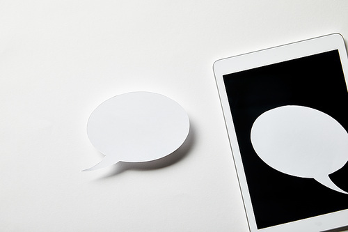 smartphone with speech bubbles on white surface