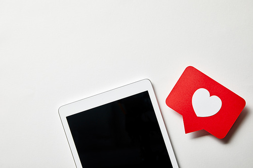 digital tablet with paper like sign on white surface