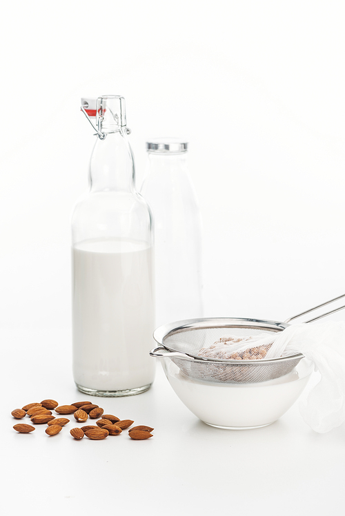 almond and chickpea vegan milk in bowl and bottle near ingredients