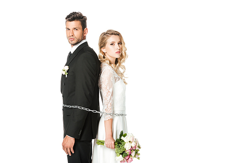 young newlyweds tied with chain back to back and  isolated on white