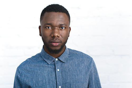Confident african american man by white wall