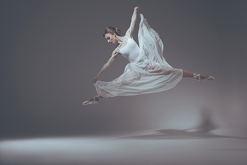 beautiful ballet dancer jumping in white dress