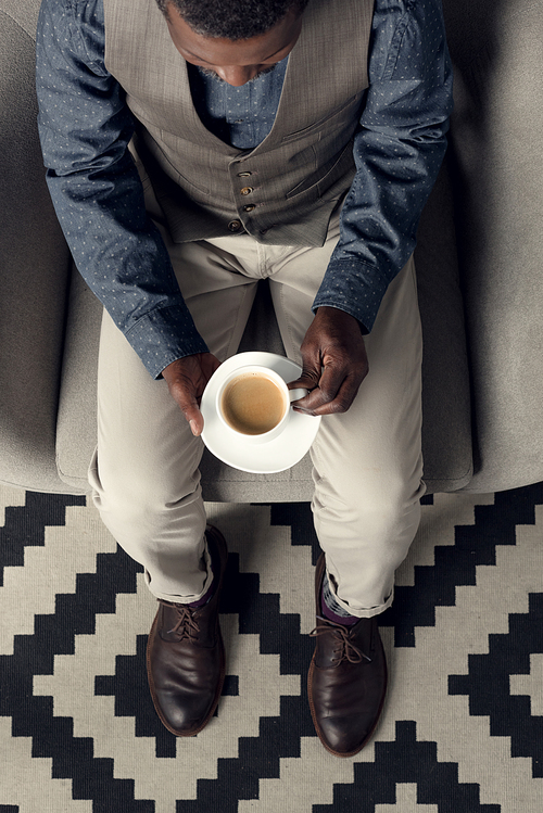 high angle view of stylish african american man with coffee cup