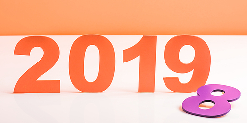 coral paper cut 2019 numbers and violet number 8 on white surface, color of 2019 concept