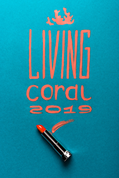 color of year 2019 handwritten lettering with coral lipstick on blue background