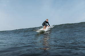 surfer riding wave on surf board in ocean