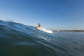 woman surfing the wave on surf board in ocean