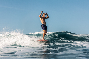 active surfer having fun and riding wave in ocean