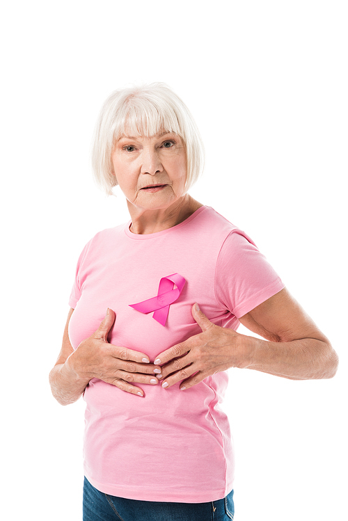 senior woman with pink ribbon touching breast and  isolated on white, cancer concept