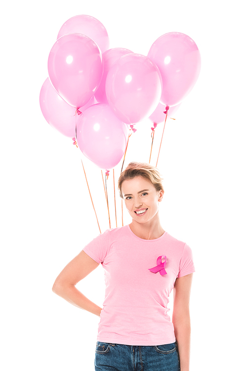 middle aged woman holding pink balloons and smiling at camera isolated on white, breast cancer concept