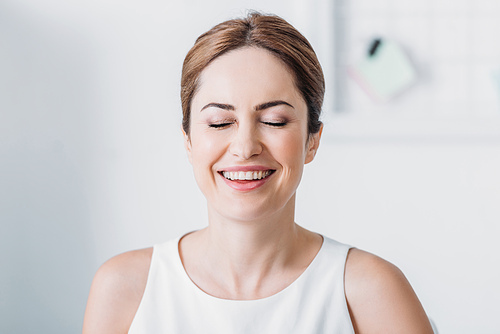 close-up portrait of beautiful happy woman with closed eyes