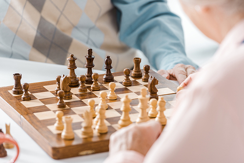 close up of senior couple playing chess together