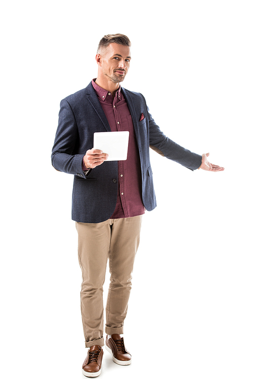 handsome stylish man in jacket holding digital tablet and doing invite gesture isolated on white