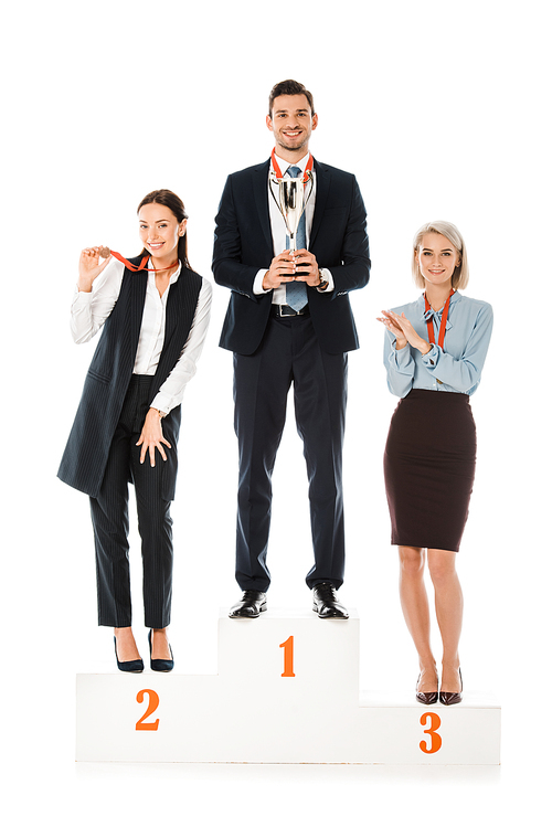 successful businesspeople holding awards while standing on winners podium isolated on white