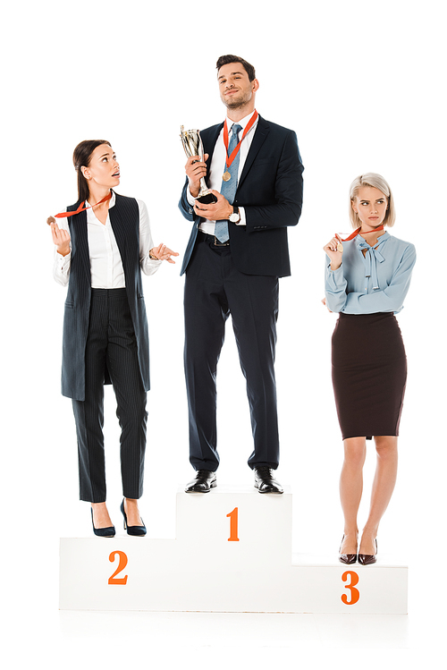 businesspeople holding awards while standing on winners podium isolated on white