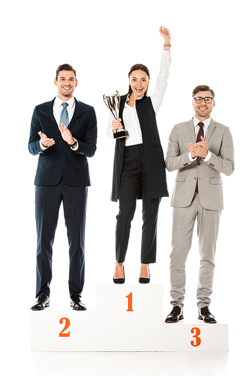 professional businesspeople holding awards while standing on winners podium isolated on white