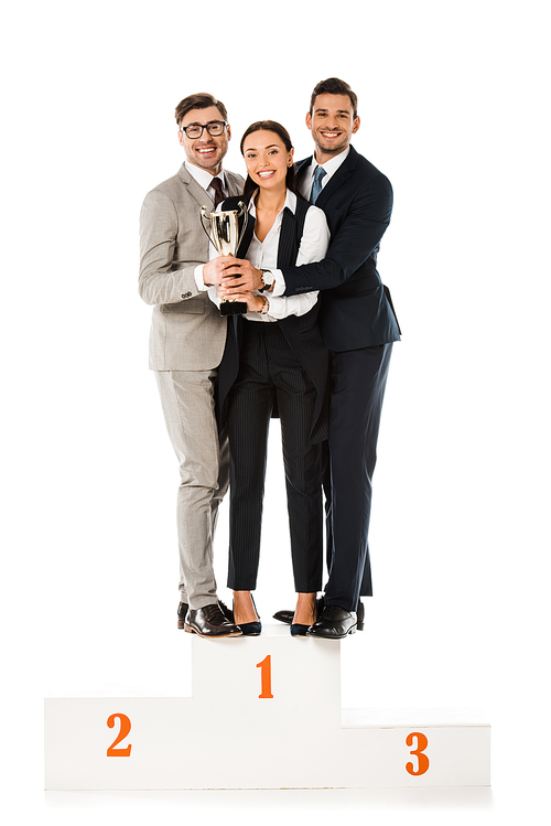 business team holding trophy cup while standing on winners podium together isolated on white
