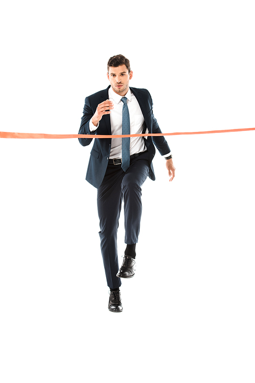 handsome businessman in suit running to finishing line isolated on white
