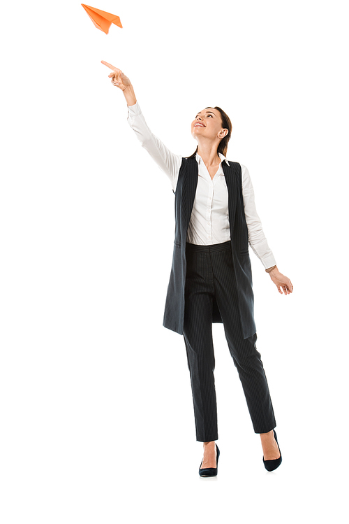 attractive businesswoman throwing paper plane, isolated on white