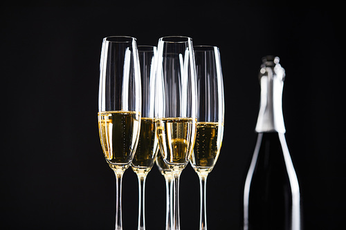 glasses and bottle of champagne for celebrating christmas, isolated on black