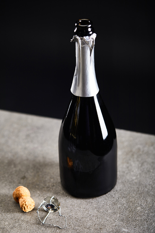 bottle of champagne with cork for celebrating christmas on black