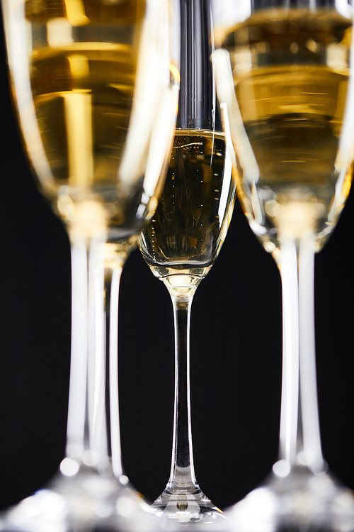 glasses of sparkling wine for celebrating christmas, isolated on black