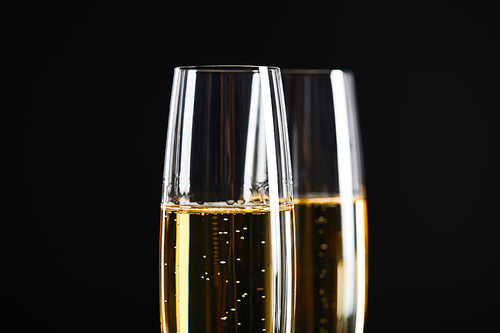 close up of champagne in glasses for celebrating christmas, isolated on black