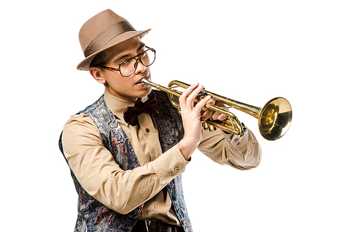 handsome mixed race male musician in stylish hat and eyeglasses playing on trumpet isolated on white