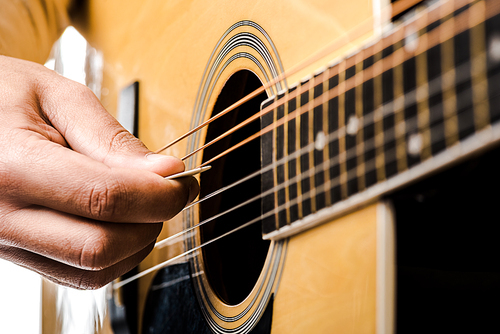 partial view of male musician playing on acoustic guitar isolated on white