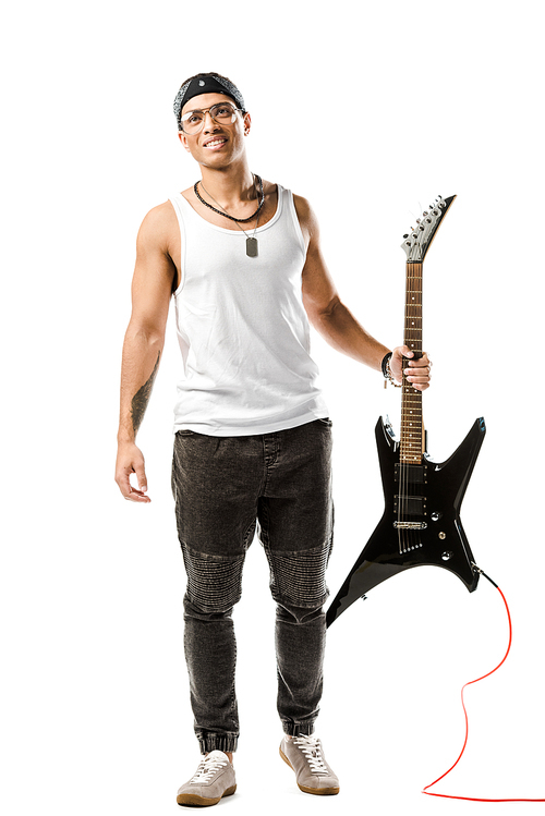 happy young male rock musician posing with black electric guitar isolated on white