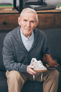 retired man choosing between classic and modern shoes