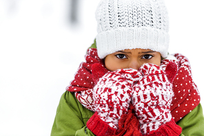 close up view of african american child in knitted hat, mittens and scarf  in winter