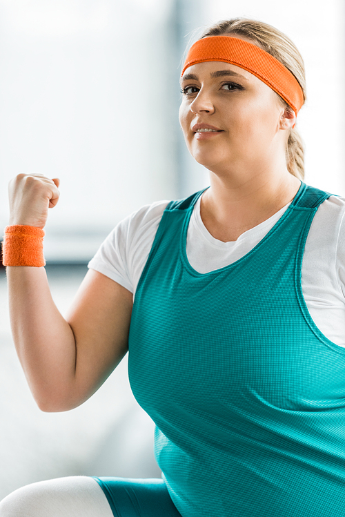 plus size girl in sportswear exercising in gym