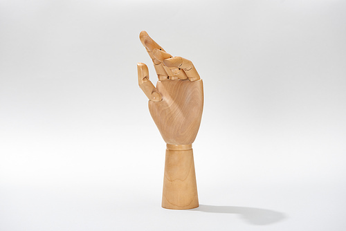 Wooden hand of puppet on grey background