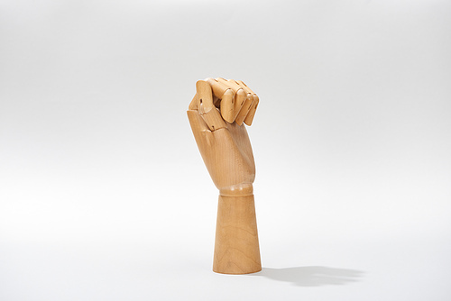 Wooden hand of puppet on grey background with copy space