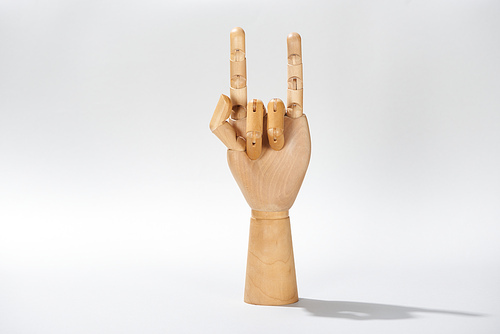 Wooden hand with rock sign on grey background