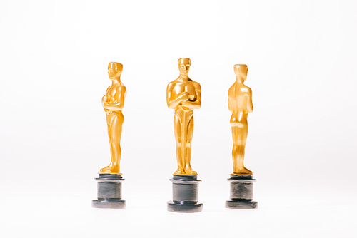 shiny hollywood oscar award statuettes isolated on white