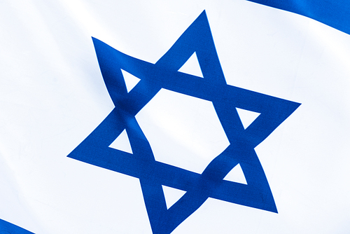 close up of blue star of david on flag of israel