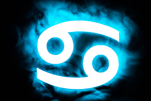 blue illuminated Cancer zodiac sign with smoke on background