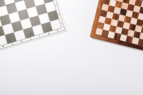 Top view of checkerboards isolated on white with copy space