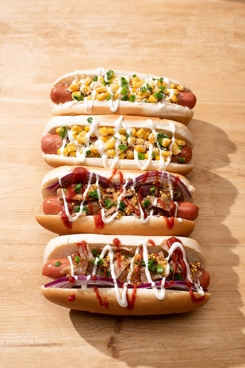 delicious hot dogs with red onion,corn on wooden table