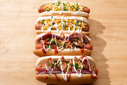 delicious hot dogs with red onion,corn on wooden table