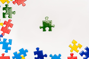 Top view of bright pieces of puzzle on white background, autism concept